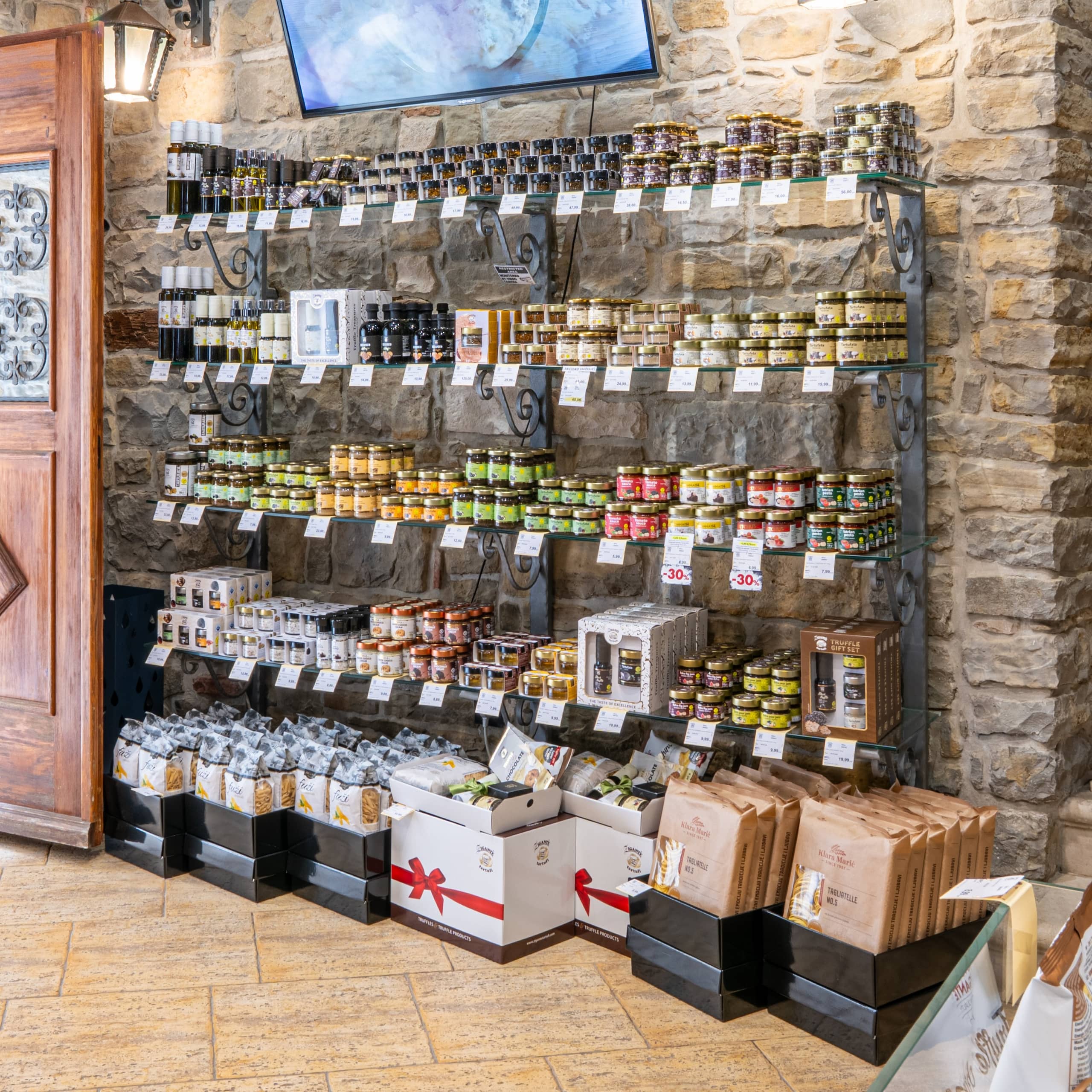 Wall display of truffle oils and sauces in the Zigante Tartufi Grožnjan shop